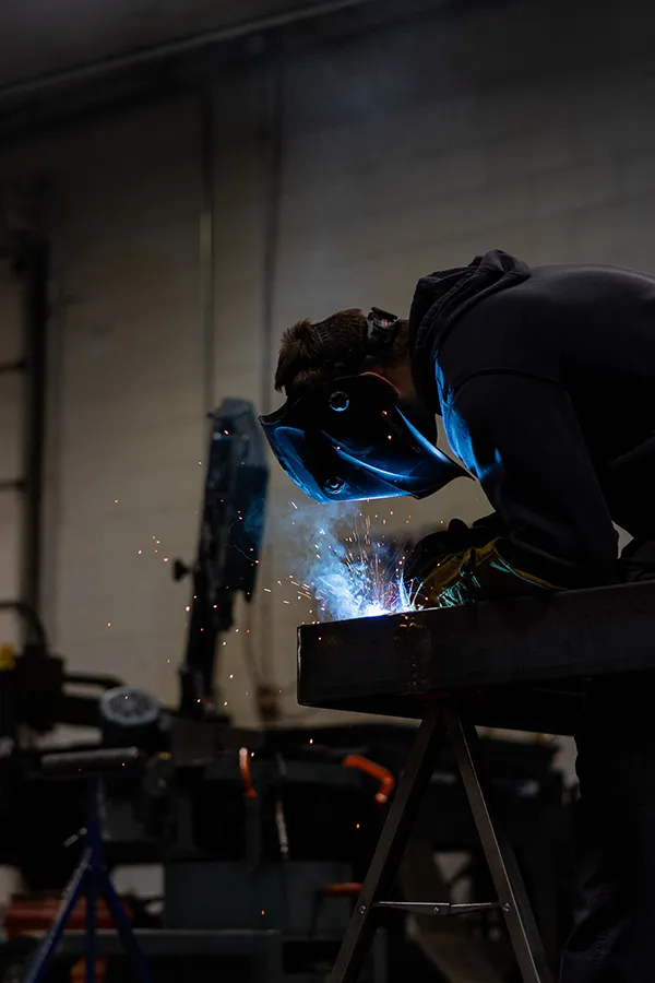 Welder joining a steel assembly in the fabrication shop
